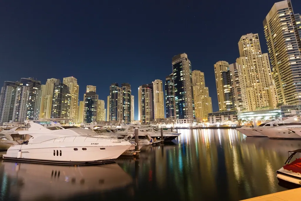 Luxury yachts moored in Dubai Marina at night